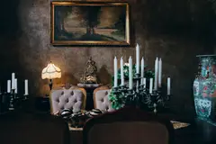 Sophisticated vintage room with elegant decor, candlelight, and classic artwork