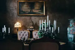 Sophisticated vintage room with elegant decor, candlelight, and classic artwork