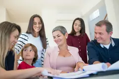 Family gathered around a table discussing estate documents with a professional